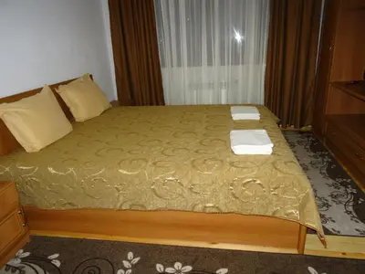a bedroom with a bed with two towels on it at Ognyanovata Guest House in Dobărsko