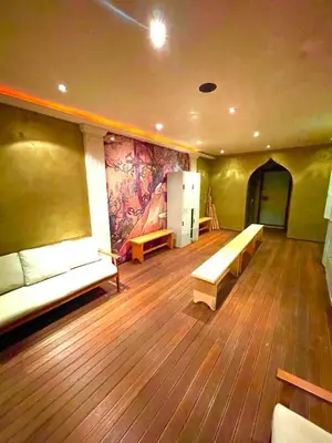 a room with benches and a painting on the wall at Костадинов 2 in Pamporovo
