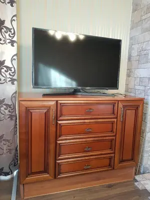 a television on top of a wooden dresser at Костадинов 1 in Pamporovo