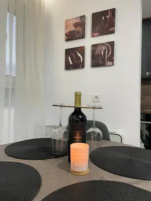 a bottle of wine and two glasses on a table at Flat Park Sandanski in Sandanski