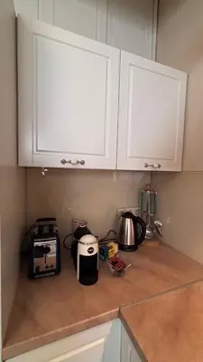 a kitchen counter with white cabinets and a toaster at Stylish 2 BR apart in top center in Sofia