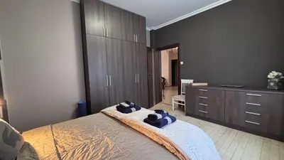 a bedroom with a bed with blue towels on it at Stylish 2 BR apart in top center in Sofia