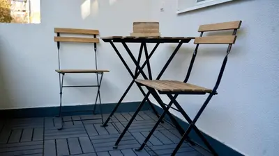 two chairs and a table next to a wall at Downtown Gem in Plovdiv