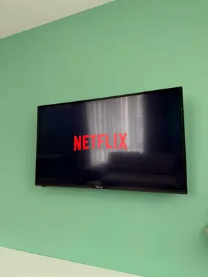 a television on a wall with the netflix sign on it at Downtown Gem in Plovdiv
