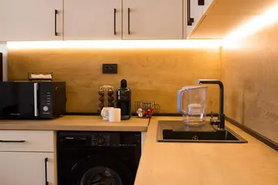 a kitchen with a sink and a microwave at Serenity Apartment Bansko in Bansko