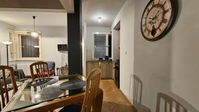 a dining room and kitchen with a clock on the wall at Colorful 2BD Apartment next to Serdika Center by Flat Mаnager in Sofia