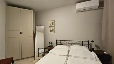 a bedroom with a bed and a air conditioner at Colorful 2BD Apartment next to Serdika Center by Flat Mаnager in Sofia