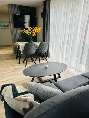 a living room with a couch and a table at July apartaments in Velingrad