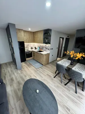 a living room with a table and a kitchen at July apartaments in Velingrad