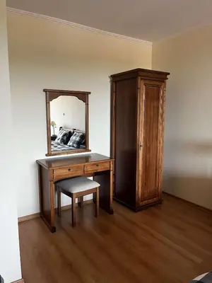 a bedroom with a wooden desk and a mirror at Apartment Geronimo in Pamporovo
