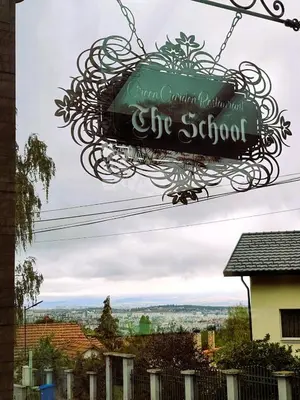 a sign for the school hanging in front of a house at Sirius Apartment in Sofia