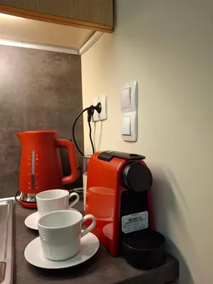 a kitchen counter with two cups and a coffee maker at Maisonette Mountain View - Euphoria Resort in Borovets