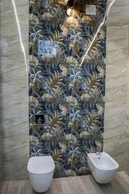a bathroom with a toilet and a wall at Хотелски комплекс Релакс in Rudozem
