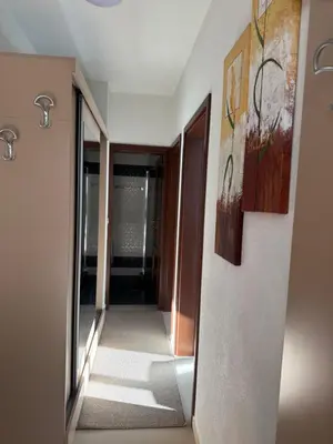 a hallway with two paintings on the wall at Апартамент Слънчев дом in Smolyan
