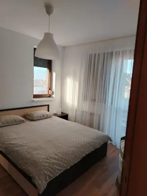 a bedroom with a bed and a window at Elegant Two Bedroom Apartment - Top Location in Bansko