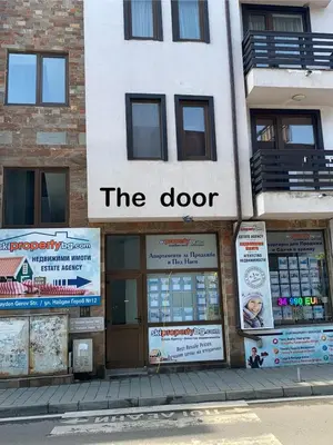 a building with a sign that reads the door at Elegant Two Bedroom Apartment - Top Location in Bansko