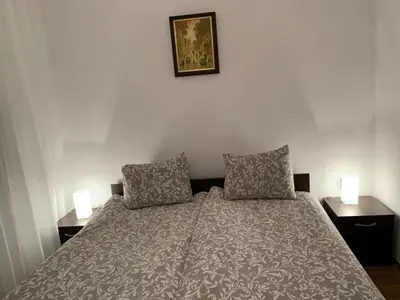 a bedroom with a bed with two pillows on it at Elegant Two Bedroom Apartment - Top Location in Bansko