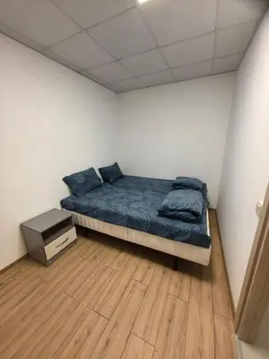 a bedroom with a bed and a wooden floor at ApartBelisimo4 in Sofia