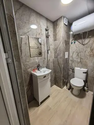 a bathroom with a toilet and a sink at ApartBelisimo4 in Sofia