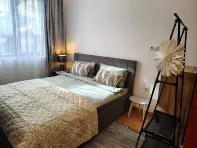 a bedroom with a bed with a flower on it at Ski lift studio in Bansko