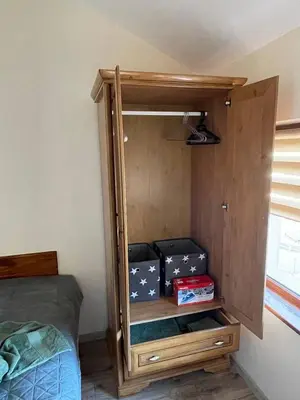 a room with a bed and a cabinet with boxes at Bansko soul relax place in Bansko