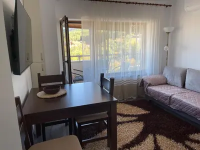 a living room with a table and a couch at Bansko soul relax place in Bansko