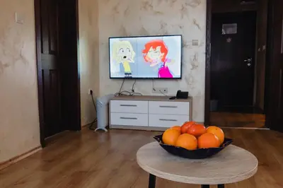 a living room with a bowl of oranges on a table at Rila Residence - next to Pirin Golf in Razlog