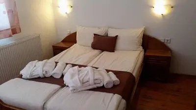 a hotel room with two beds with white towels at Villa Leventy in Banya