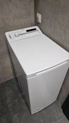 a white refrigerator sitting next to a wall at Concrete comfort in Samokov