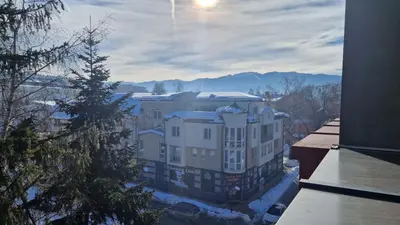 a view of a building with snow on the ground at Concrete comfort in Samokov