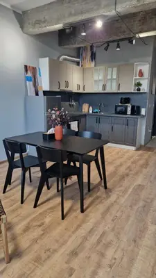 a kitchen with a black table in a room at Concrete comfort in Samokov