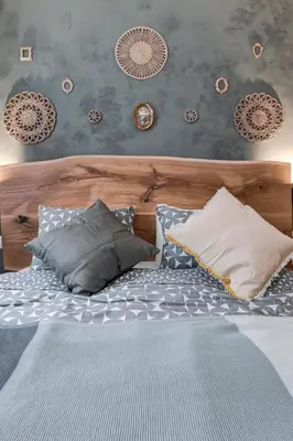 a bed with a wooden headboard and pillows on it at Veslets 4 Oldtown Stay in Sofia