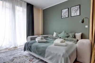 a bedroom with two beds and a large window at Veslets 4 Oldtown Stay in Sofia