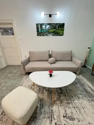 a living room with a couch and a coffee table at Florence family 2BDR Apt - min from Serdika w WiFi in Sofia