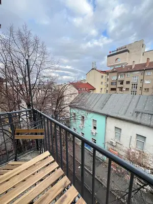 a wooden bench sitting on top of a balcony at Florence family 2BDR Apt - min from Serdika w WiFi in Sofia