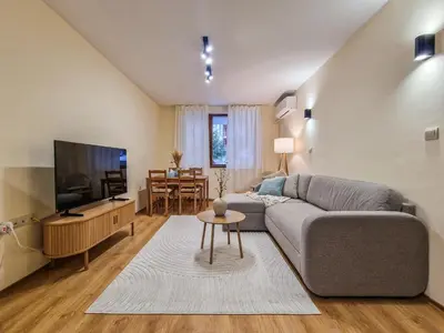 a living room with a couch and a flat screen tv at Relaxing Stay in Kosara Bansko Near Ski Lift by Flat Mаnager in Bansko