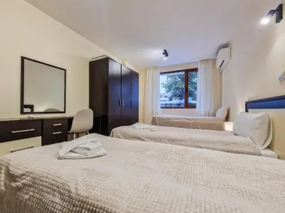 a hotel room with two beds and a mirror at Relaxing Stay in Kosara Bansko Near Ski Lift by Flat Mаnager in Bansko