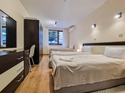 a hotel room with two beds and a flat screen tv at Relaxing Stay in Kosara Bansko Near Ski Lift by Flat Mаnager in Bansko