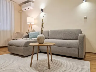 a living room with a couch and a table at Relaxing Stay in Kosara Bansko Near Ski Lift by Flat Mаnager in Bansko
