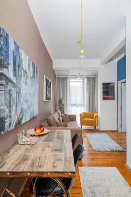 a living room with a table and a couch at Cozy and Central 2BD Flat - At the Heart of It All by Flat Mаnager in Sofia