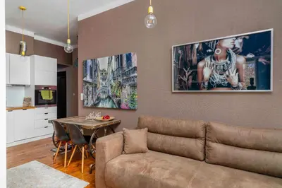 a living room with a couch and a table at Cozy and Central 2BD Flat - At the Heart of It All by Flat Mаnager in Sofia