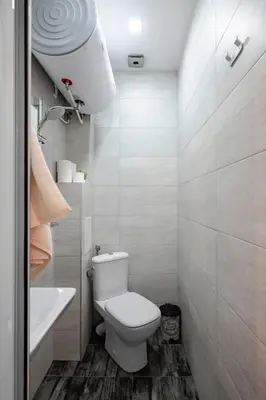 a white bathroom with a toilet and a sink at Cozy and Central 2BD Flat - At the Heart of It All by Flat Mаnager in Sofia