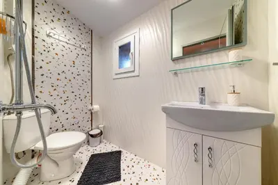 a bathroom with a sink and a toilet at Апартамент за гости Райково in Smolyan