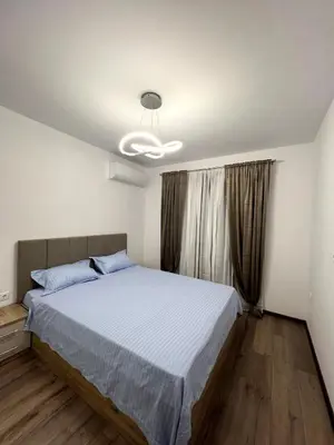 a bedroom with a large bed in a room at Atayana Apartment in Sofia