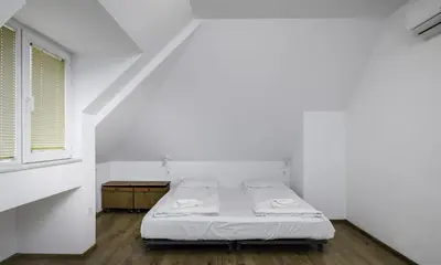 a bed in a white room with a window at Charming & Cozy 2BD Apartment with Natural Light by Flat Mаnager in Sofia