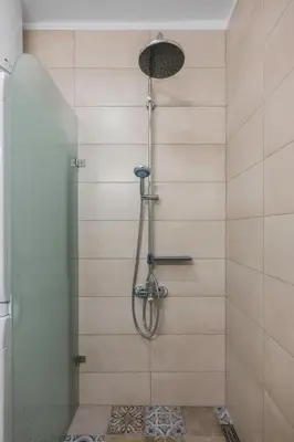 a shower with a shower head in a bathroom at Charming & Cozy 2BD Apartment with Natural Light by Flat Mаnager in Sofia