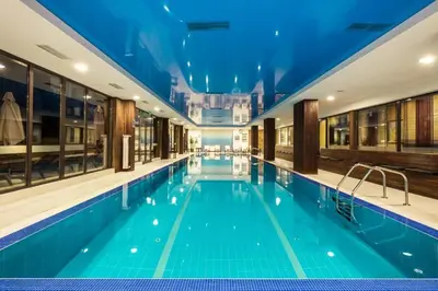 a large swimming pool with a blue ceiling at Bansko lodge 500m from ski lift in Bansko