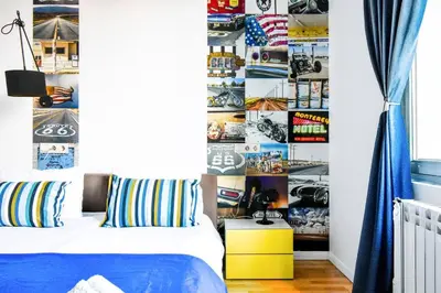 a bedroom with a bed and a wall of pictures at Center Stay Stylish 2BR near Serdika Metro in Sofia