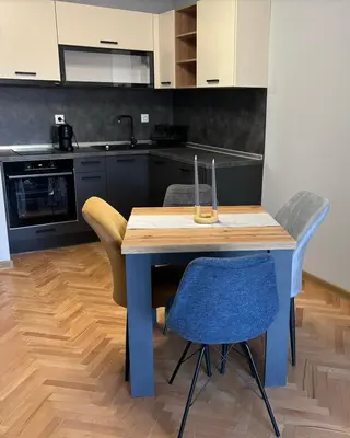 a kitchen with a blue table and chairs at Боко 16-18 in Sofia
