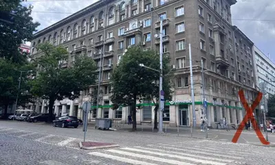 a large building on a city street with an orange ribbon at Боко 16-18 in Sofia